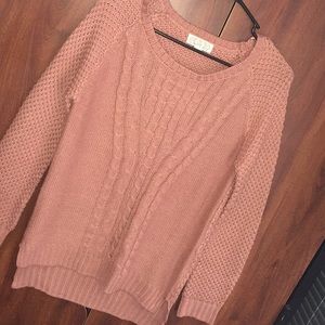 Long sleeved, coral sweater.